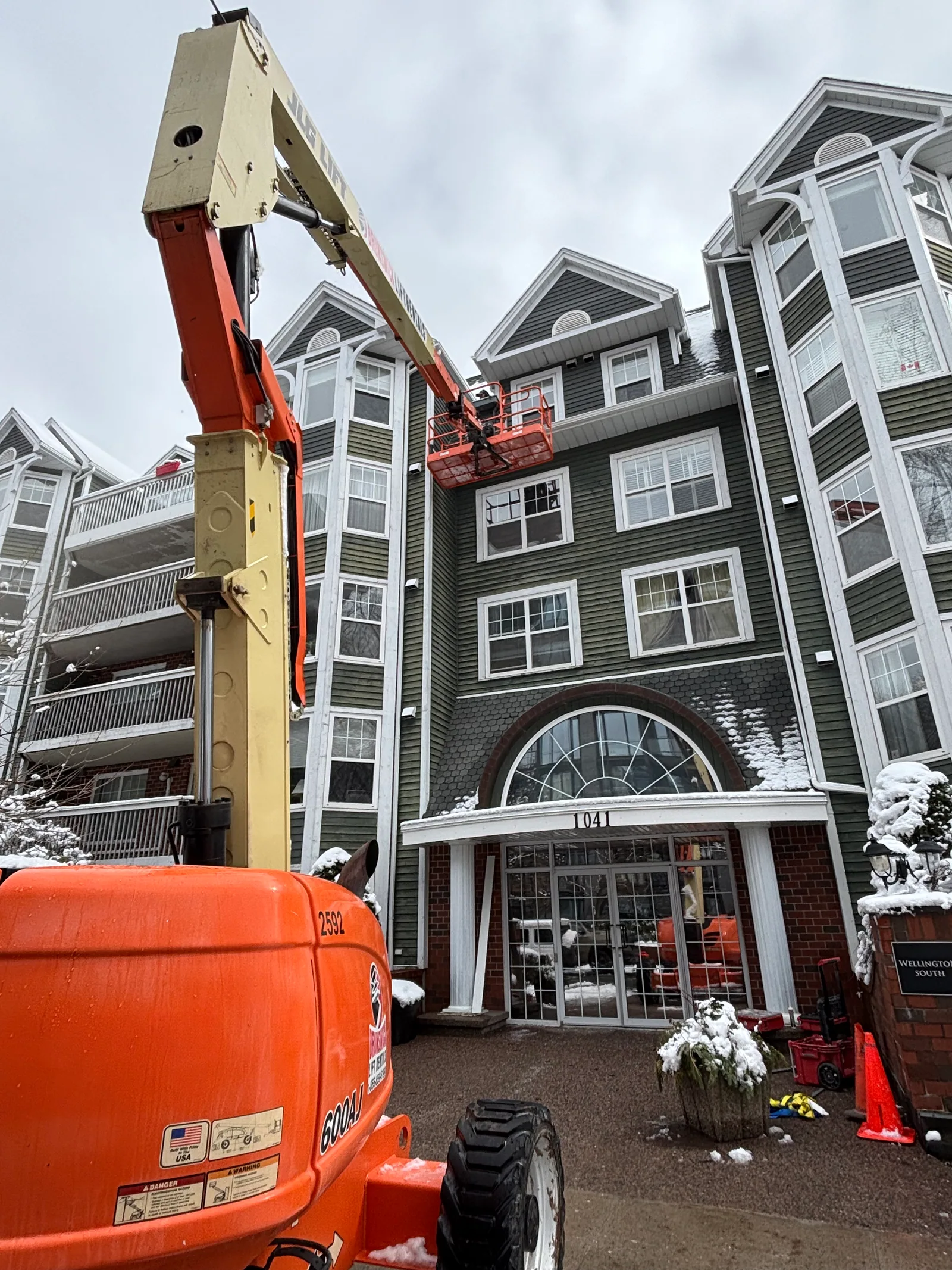 Crew member working from the boom lift basket