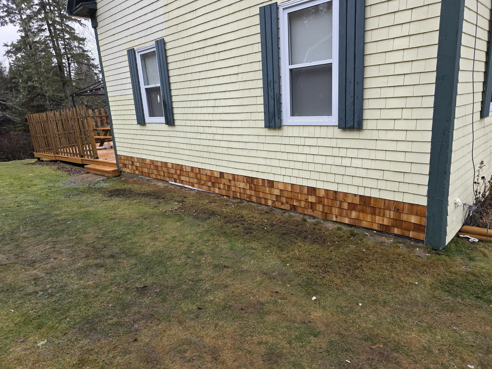 Repaired lower exterior wall with new wood cladding on a Halifax-area home