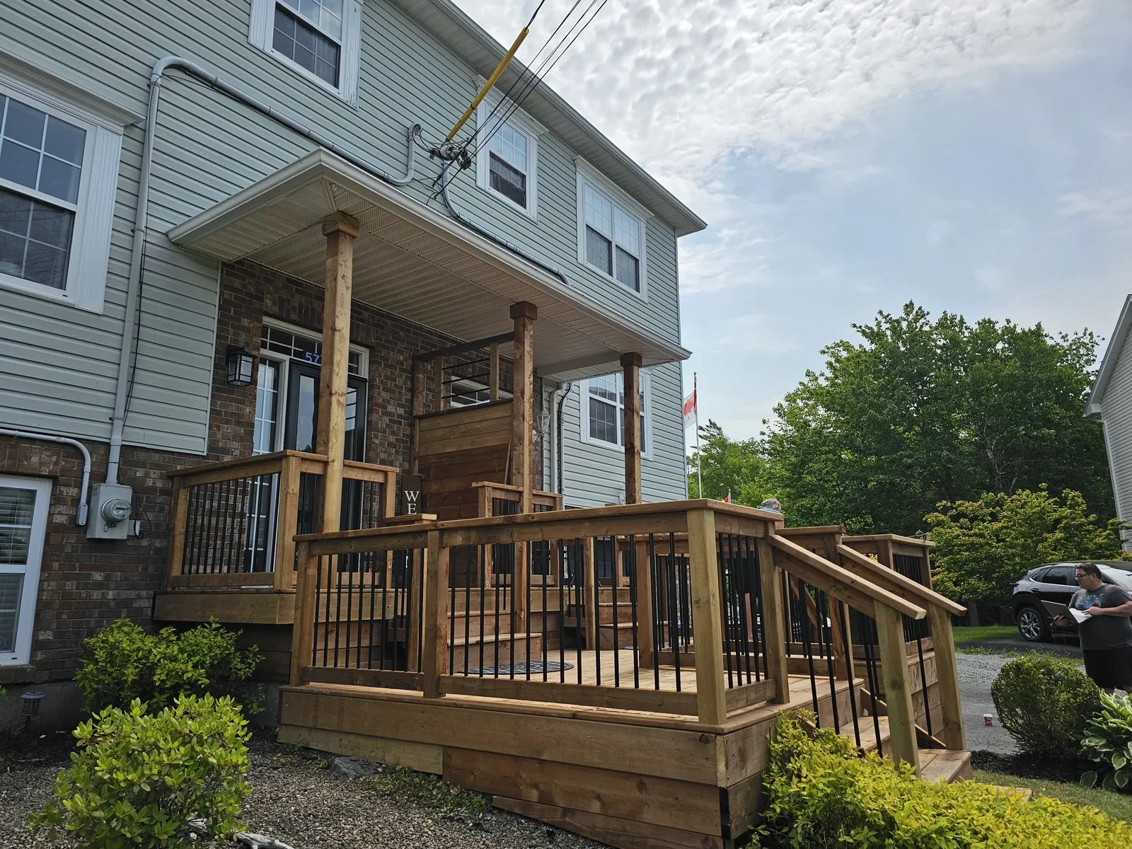 Railings and black balusters installed on the new front deck