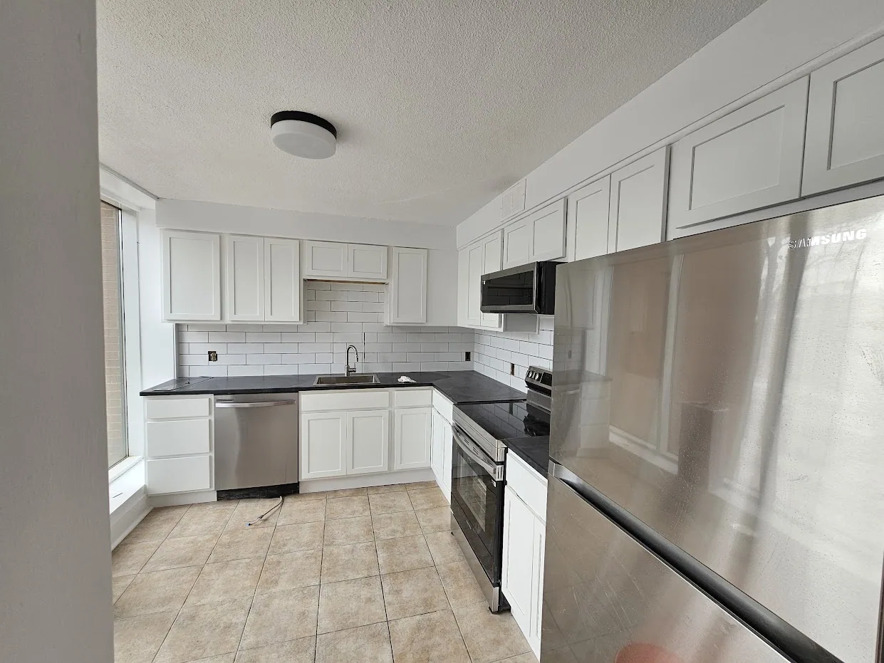 Finished kitchen renovation with white cabinetry and subway-tile backsplash